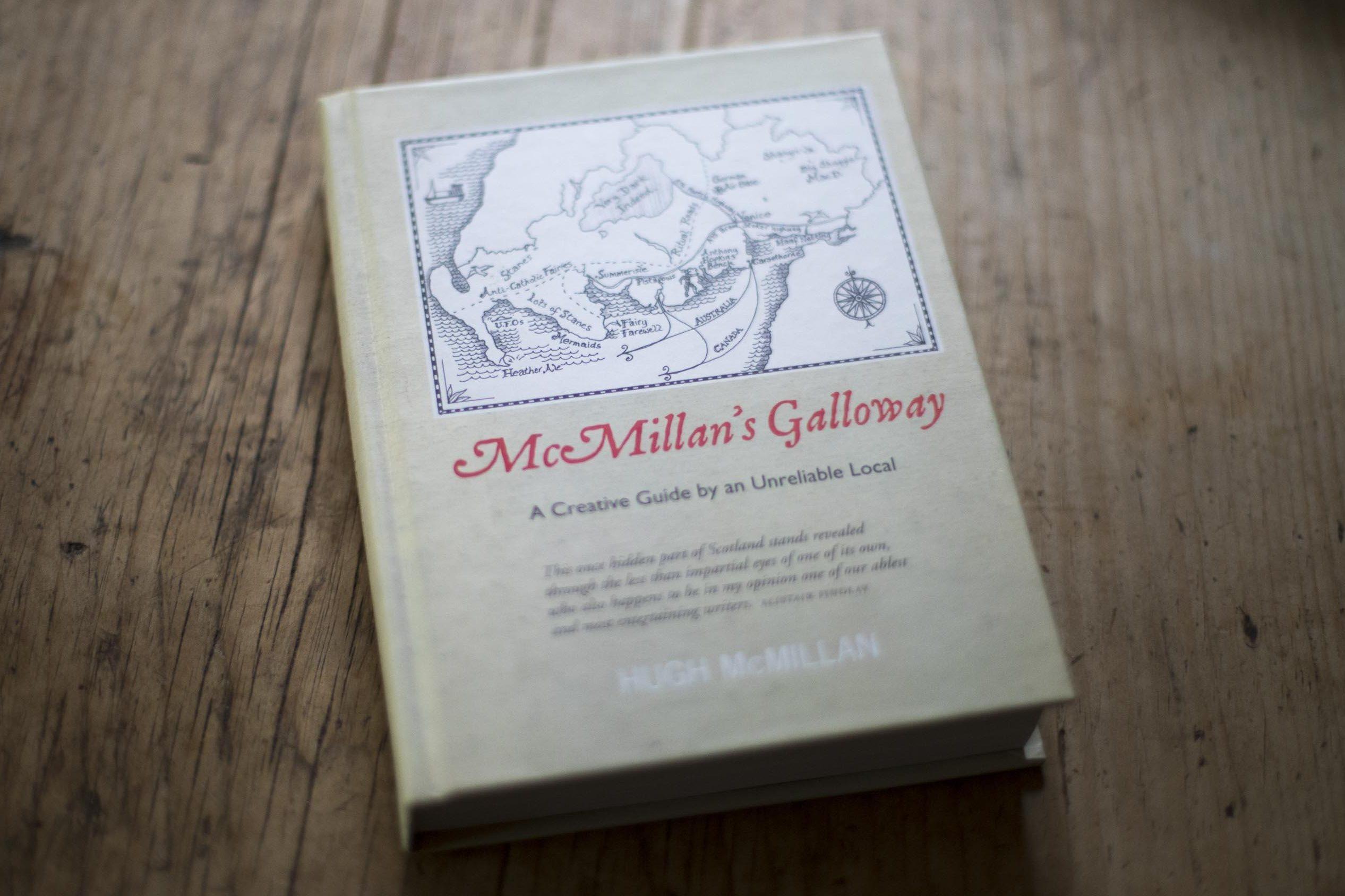 Hugh McMillan's book 'Mcmillan's Galloway sits on a wooden surface.