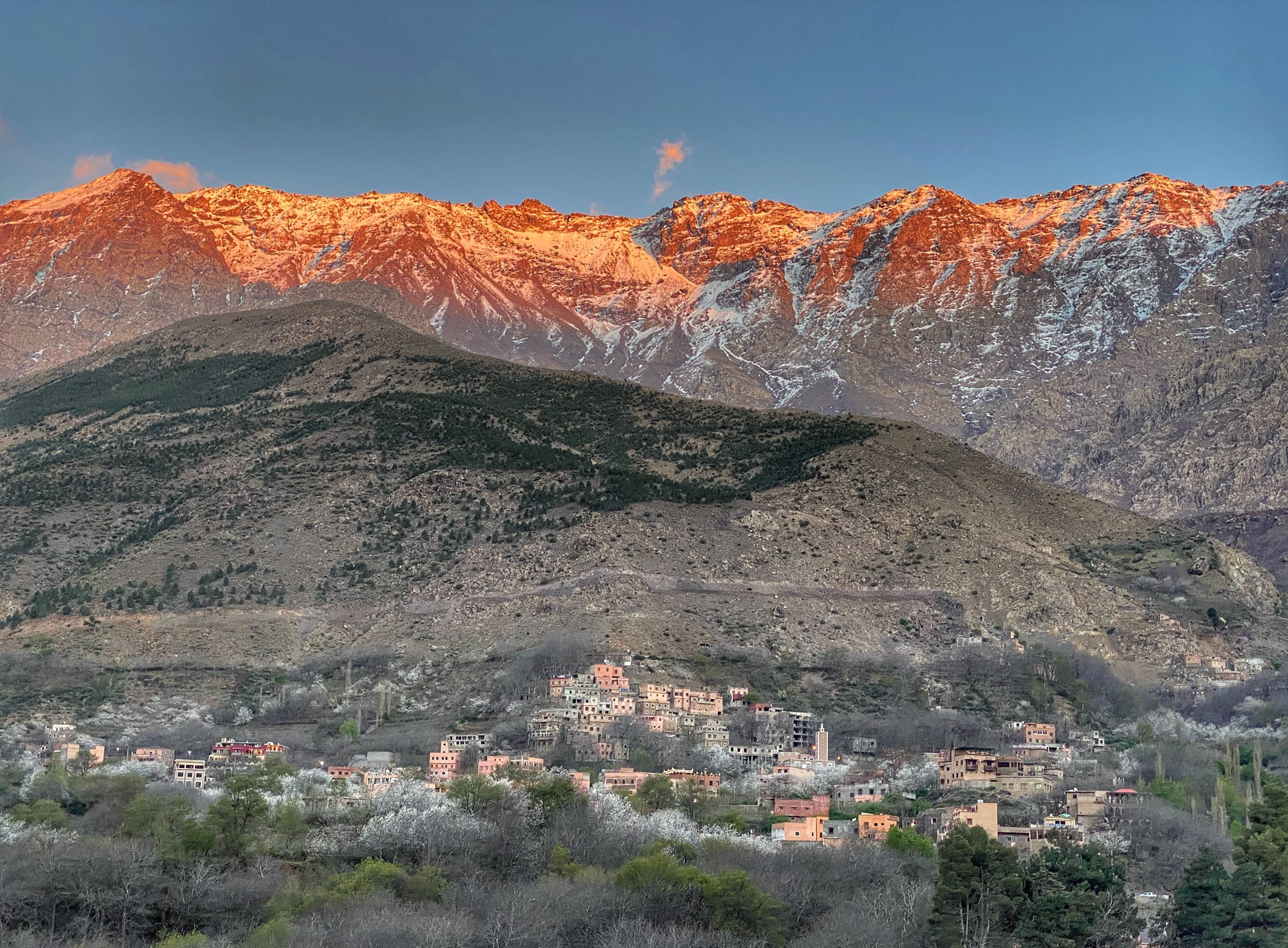 Sunset over the Atlas Mountains in Morocco. A small village sits in the valley.