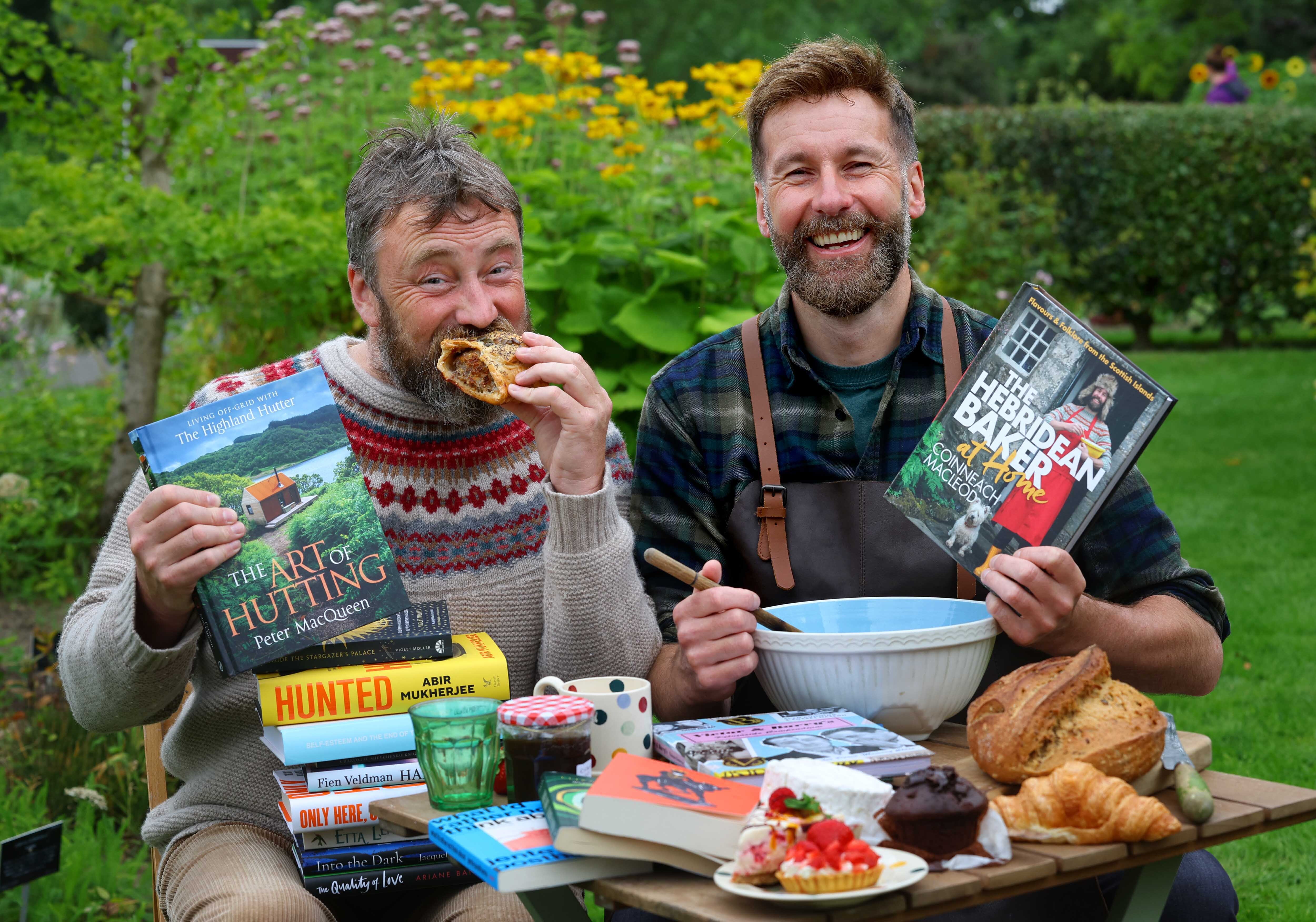 WBF 2024 Programme Launch PR image. Peter MacQueen and Coinneach MacLeod at a picnic with baked goods and books.