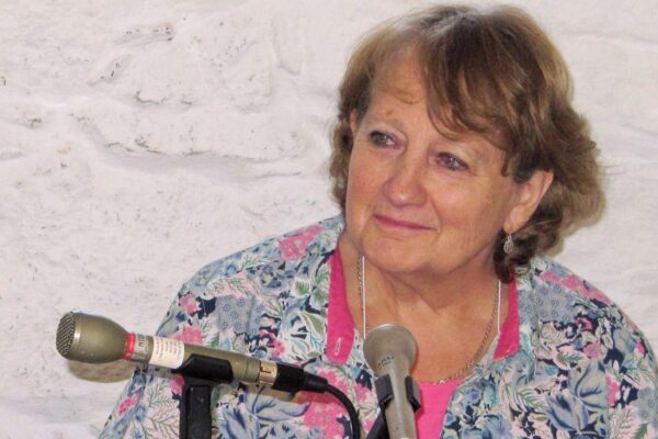 Anne Brown sitting in front of microphones whilst being interviewed.