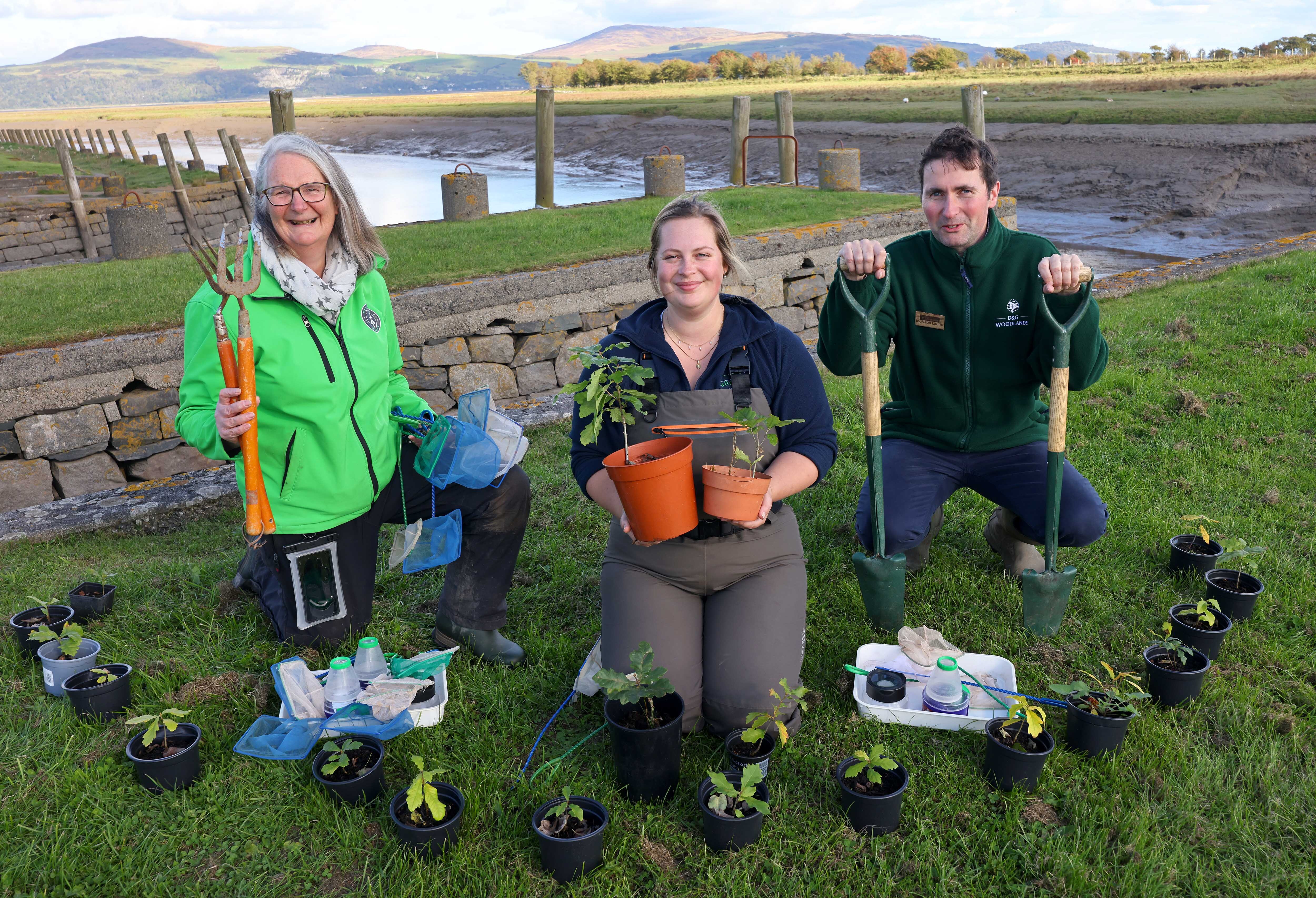 Three event guides for Wigtown Book Festival coastal fringe events, surrounded by potted plants at Wigtown harbour