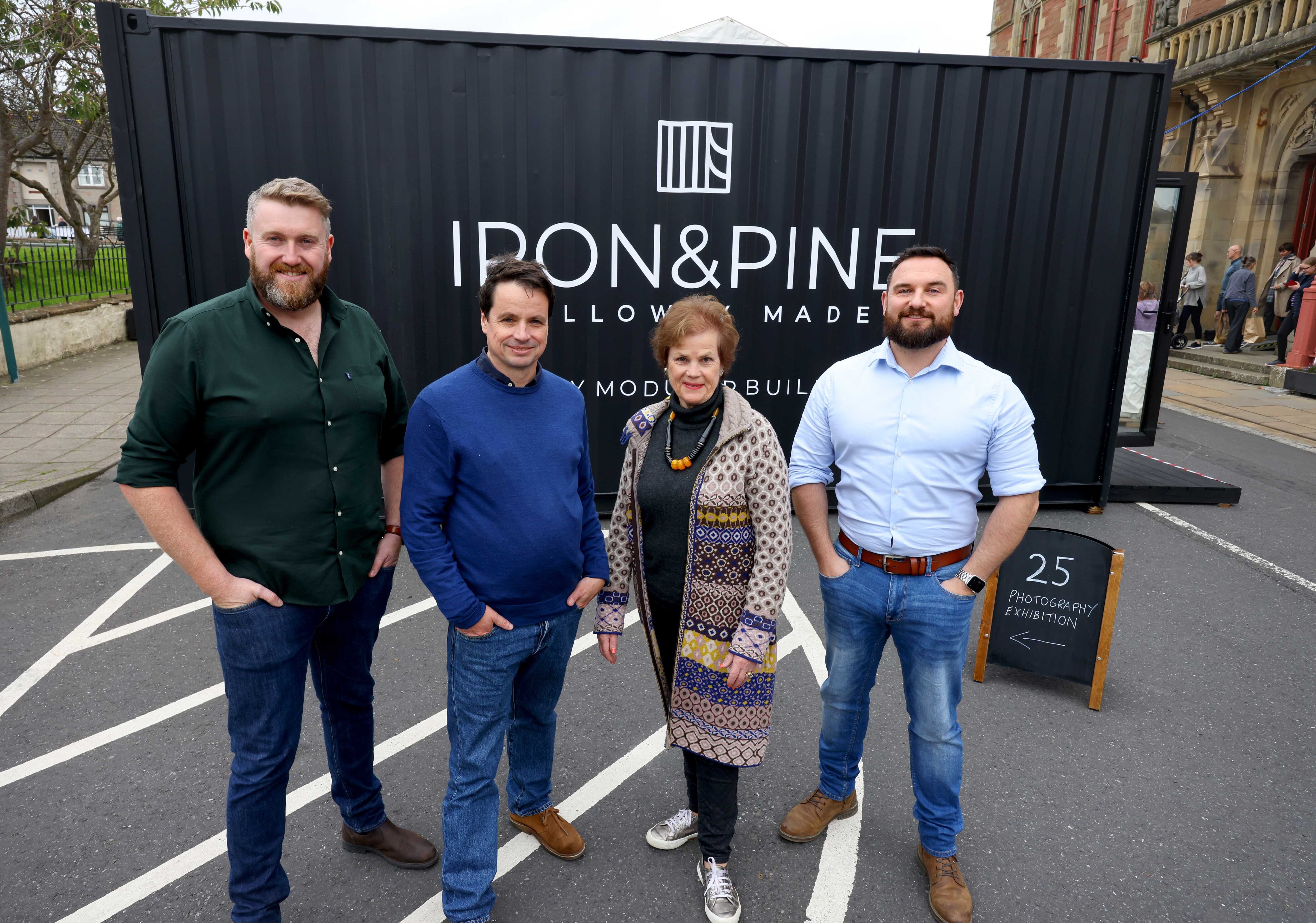 Two Iron and Pine executives, stood with Festival Director Adrian Turpin and Festival Chair Cathy Agnew, outside the Iron and Pine exhibition space, made from a shipping container.