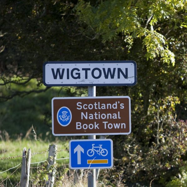 Arriving in Wigtown, Scotland's National Book Town. Road signage on a grassy verge