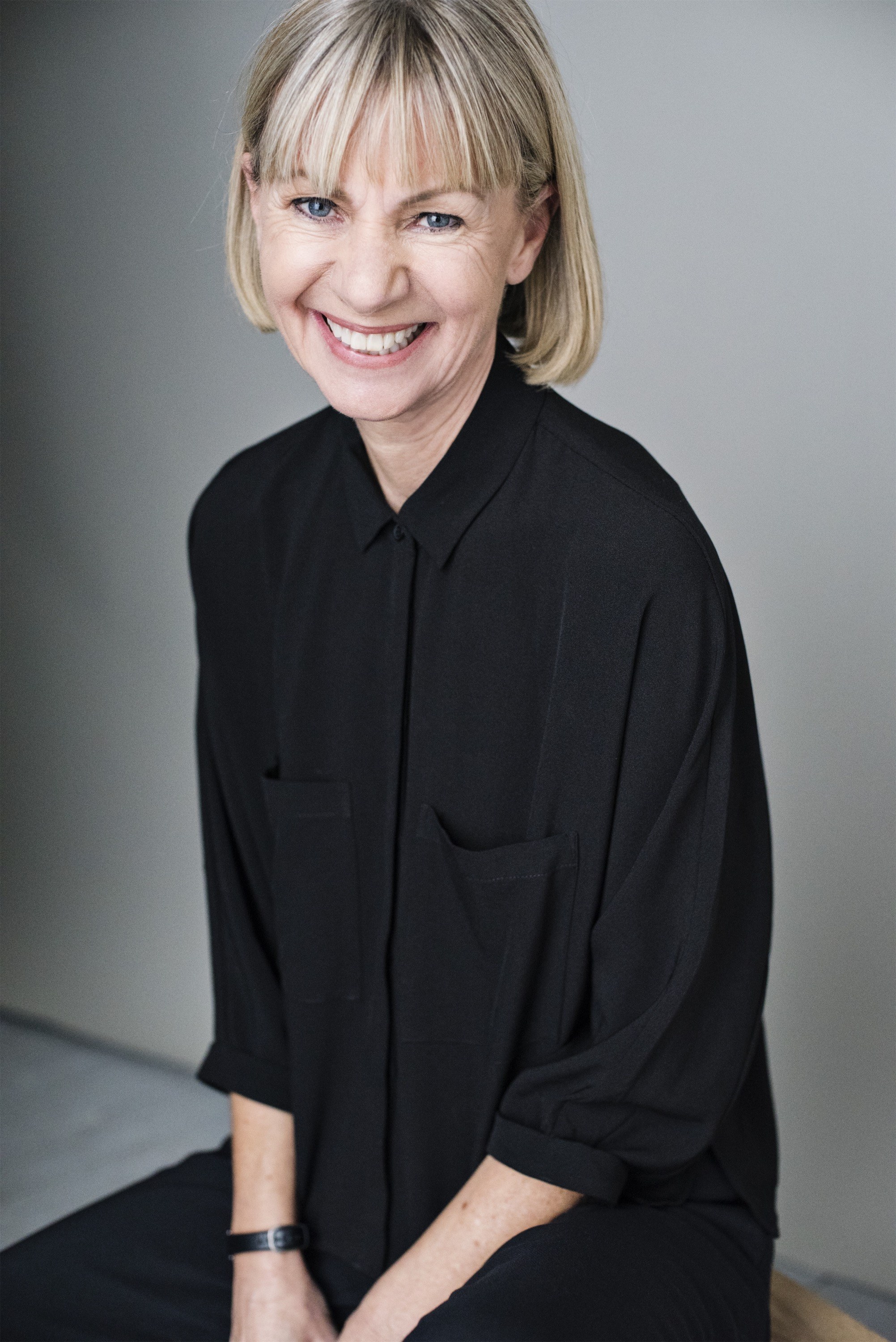 Author Kate Mosse sitting down smiling.