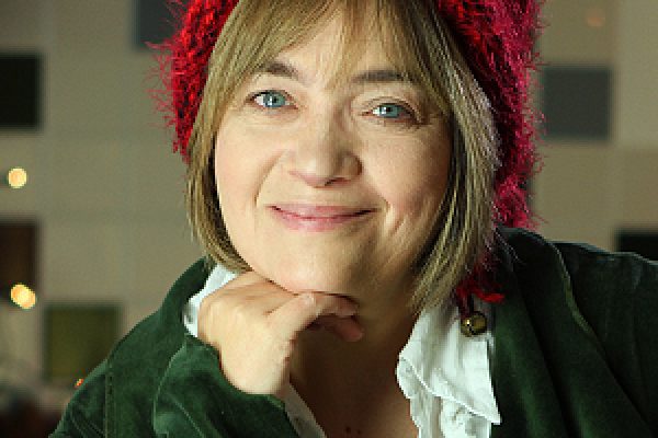 Headshot of Renita Boyle wearing a green jacket and red hat.