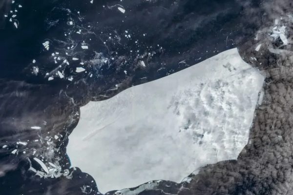 A floating iceburg in the sea as seen from space.