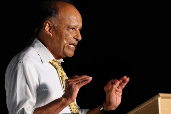 Professor Sir Partha Dasgupta speaks at a lectern.