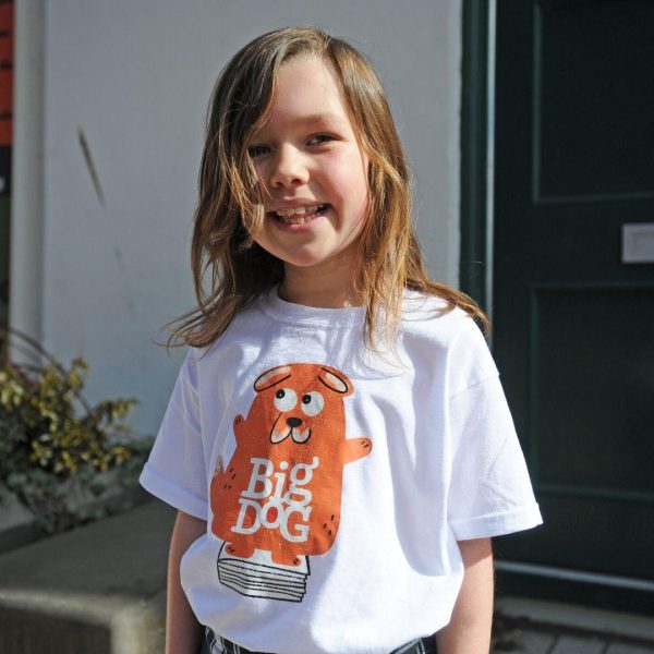 A young child wears a Big Dog book festival t-shirt illustrated with the rusty coloured big dog mascot.