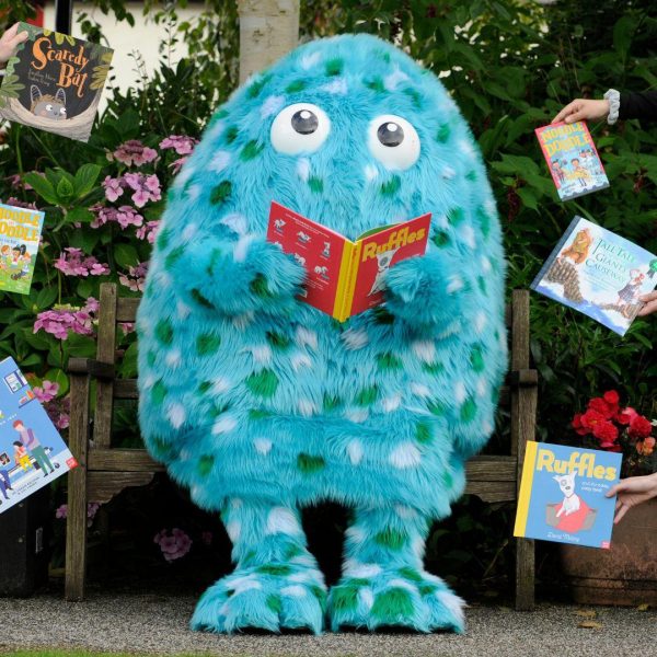Big Wig, the mascot of Wigtown Book Festival's children's festival. Big Wig is a fluffy, turquoise creature with green and white spots. Shown is the Big Wig costume, worn by a staff member during Wigtown during the festival.