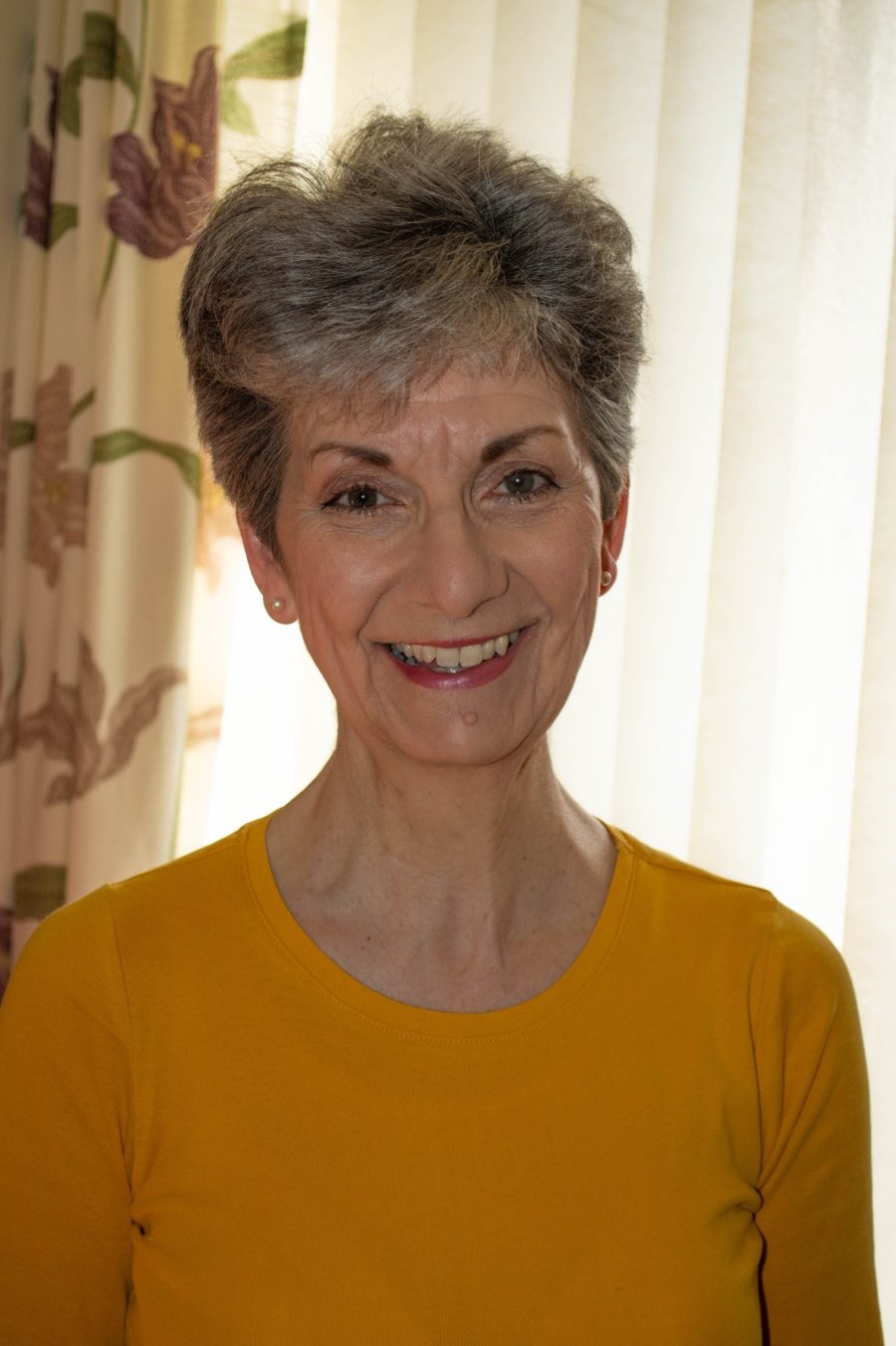 Headshot of author Elaine Barton in front of a window.