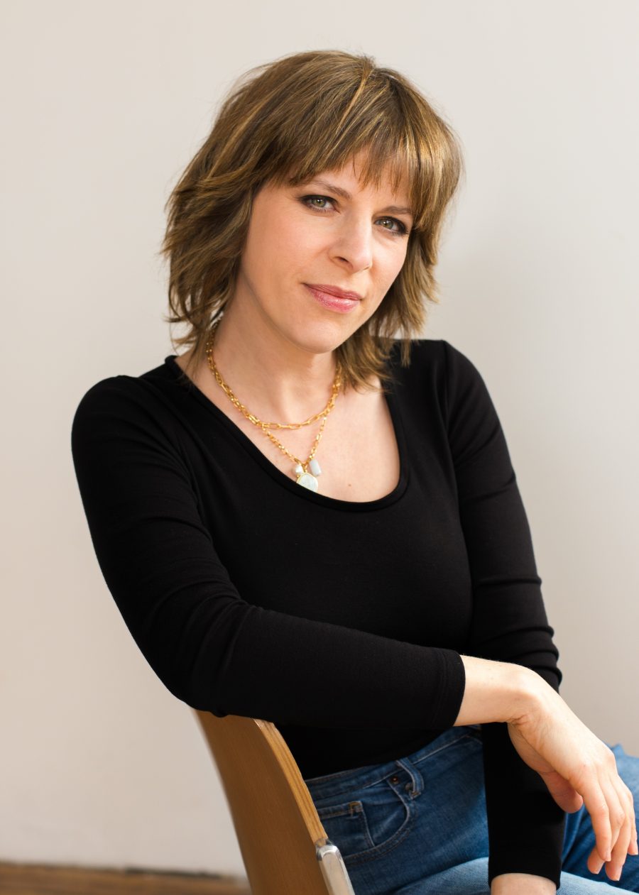 Headshot of Leah Hazard standing with her arms folded.