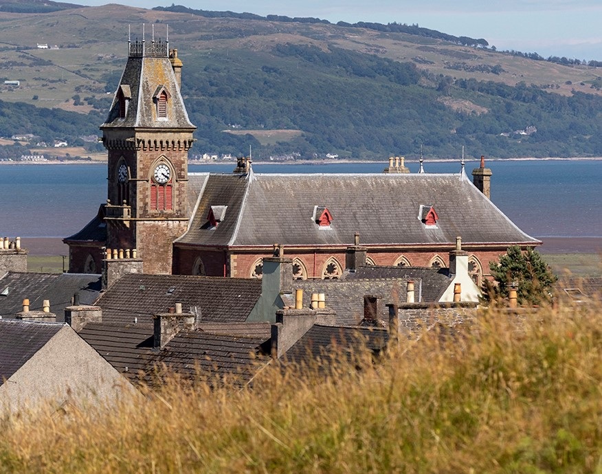 Wigtown County Buildings and rooftops from a distance. Wigtown Bay and the Galloway Hills are in the distance.