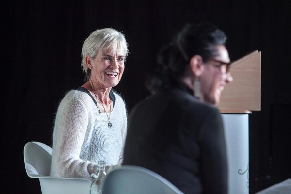 Judy Murray sitting talking on stage at her event during Wigtown Book Festival. Her chairperson is laughing beside her.