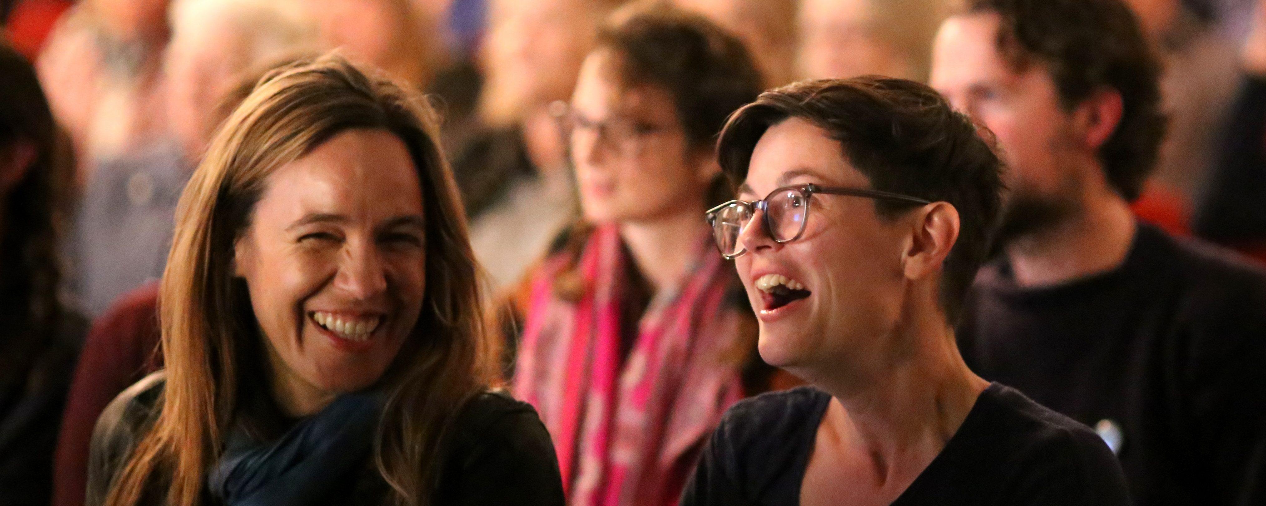 Members of an audience are laughing during an event at Wigtown Book Festival.