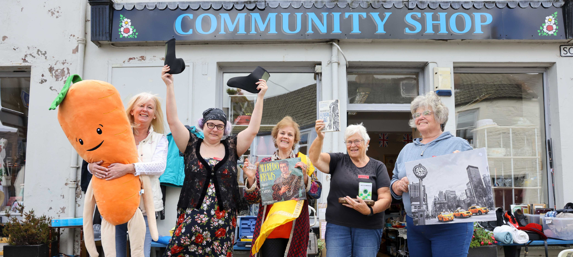 Wigtown Community Shop volunteers and Wigtown Festival Company Chair Cathy Agnew stood outside Wigtown Community Shop.